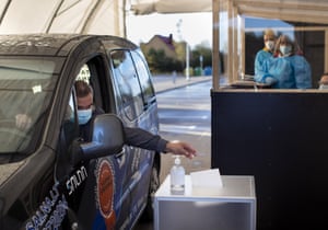 A voter casts his ballot at a drive-in polling station in Vilnius, Lithuania.
