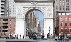 People walk in front of the arch at Washington Square Park on 22 March.