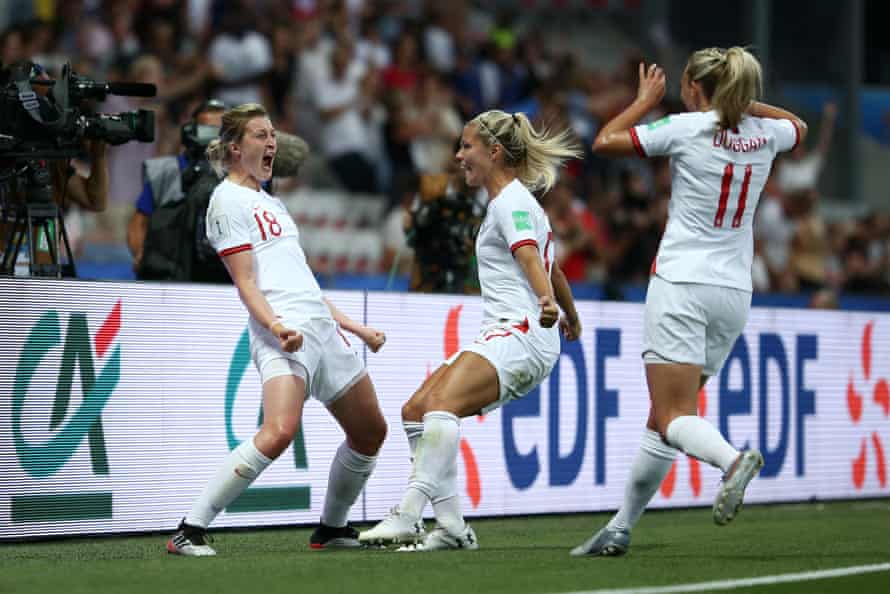 Ellen White of England celebrates with teammates after scoring her team’s first goal.