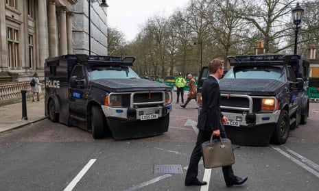Armoured police personnel carriers on a street leading to the Houses of Parliament in central London on March 24, 2017