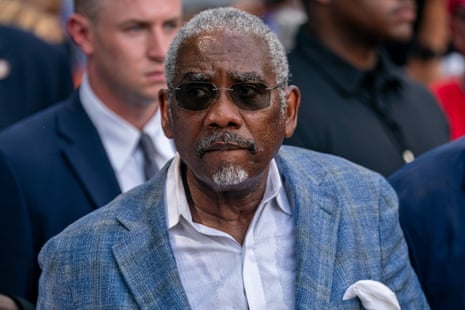 Rep. Gregory Meeks, in sunglasses and a blue blazer, looks off to the side amid a crowd