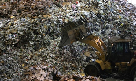 A tractor moves a pile of recyclables at the San Francisco recycling center on 22 April 2008. Recycling centers across the US are struggling.