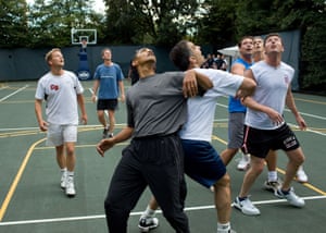 The president jostles with congressmen during a basketball game at the White House