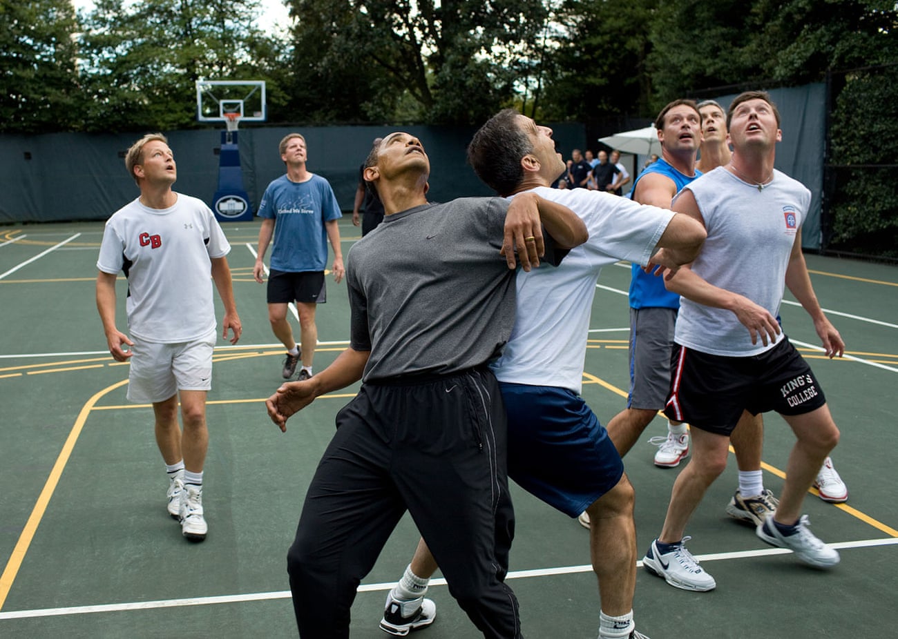 The president jostles with congressmen during a basketball game at the White House