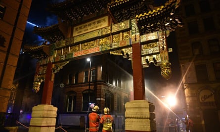 Firefighters at the scene of the blaze which ripped through a building in Manchester’s Chinatown, just yards from the ethnic quarter’s imperial arch