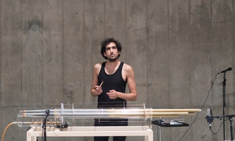 Tarek Atoui with the koto, a bundle of organ pipes set on a table frame, connected to an air compressor.