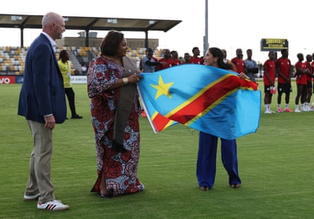 The DRC ambassador to the US, Kapinga Yvette Ngandu (centre) holds the national flag on Friday.