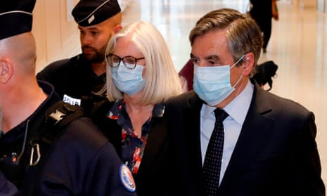 François Fillon (right) and his wife Penelope Fillon leave the Paris courthouse after being found guilty of fraud.