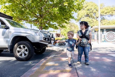 Peta Stamell crosses the road with her son in Canberra.
