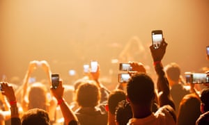 Fans using smartphones at a concert