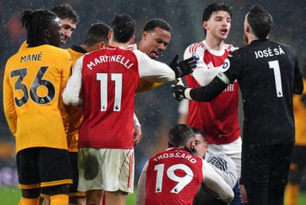 Arsenal’s Declan Rice argues with José Sá of Wolves while Leandro Trossard receives treatment at Molineux.