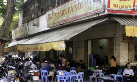 Vietnamese men drink beer at an outdoor beer parlor in Hanoi, Vietnam