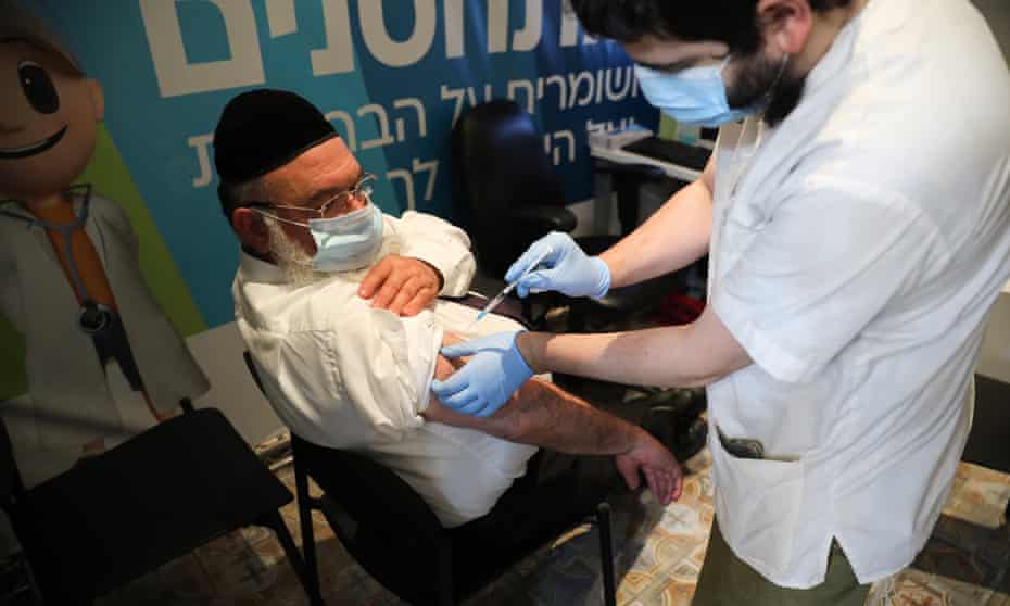 A nurse injects a man with a third shot of the Covid-19 vaccine in Jerusalem, Israel, 30 August 2021.
