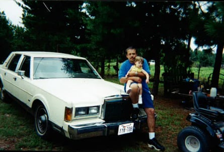 An old photograph of Robert Roberson and his daughter Nikki next to a car.