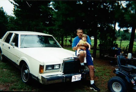 a man sitting on car with his a young girl