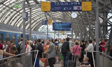 Passengers wait for delayed trains at the main station in Dresden, Germany.
