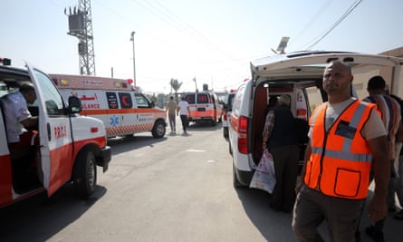 ambulances and man in high-vis jacket in foreground