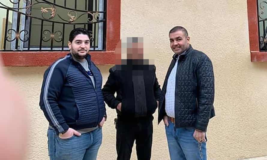 Abdul Rahman Khiti (L) poses with his brother, Syrian MP Amer Khiti (R) in front of a Syrian Ministry of Defence Recruitment Office in Douma amid Amer’s election campaign in 2020.