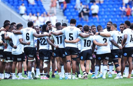 Fiji players huddle after the match