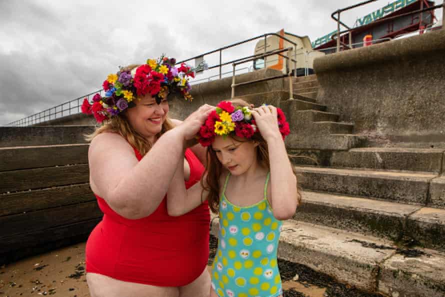 Anna Morell helps her daughter Aurelia put on her floral wreath.