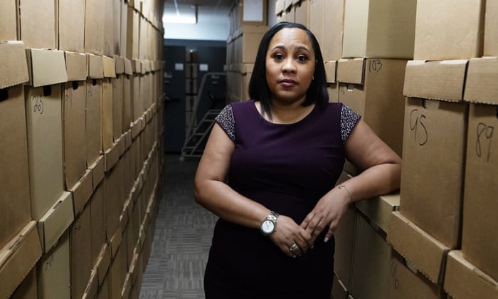 Fulton County District Attorney Fani Willis poses among boxes containing thousands of primal cases at her office, Wednesday, Feb. 24, 2021, file photo in Atlanta.