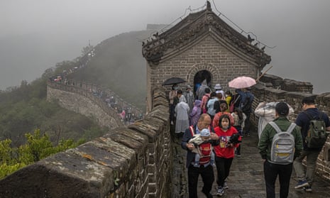 Tourists visit Mutianyu, a section of the Great Wall of China, on a rainy day in Beijing.