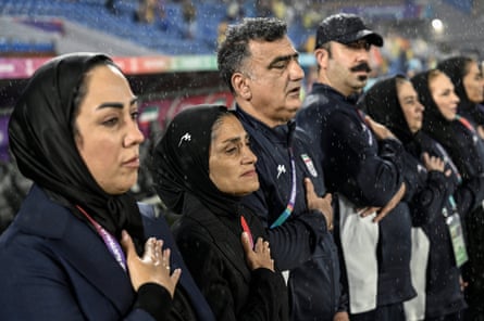 Iran head coach Marzieh Jafari and team staff during the national anthem before facing Australia in the Women’s Asian Cup