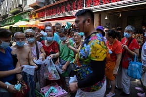 A street vendor attracts customers at a market