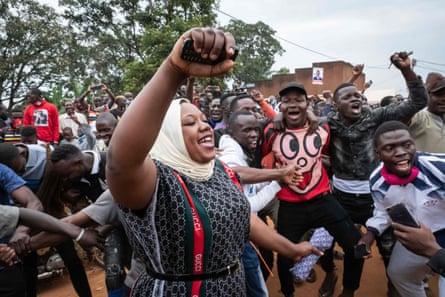 Supporters react at the arrival of Musician-turned-politician Robert Kyagulanyi also known as Bobi Wine, at a polling station in Magere, Uganda, on January 14