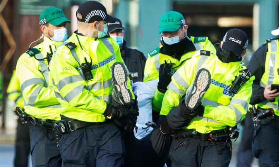 Police make an arrest during a protest in Glasgow on Saturday.