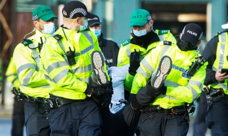 Police make an arrest during a protest in Glasgow on Saturday.