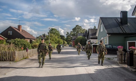 Swedish armed forces patrolling a village street in Gotland