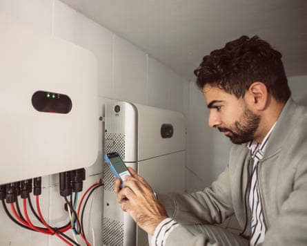 Commercial agent and technical electrician synchronize the converter and the storage battery of the solar panels through the mobile phone application