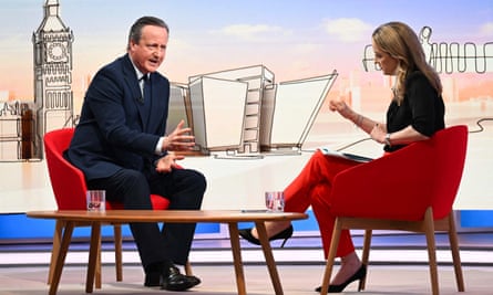 David Cameron speaks to a presenter on live TV, both are sitting on chairs with an illustration of London in the background