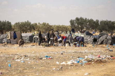African irregular migrants are seen living in makeshift tents, set on a field, after their arrival in Sfax.