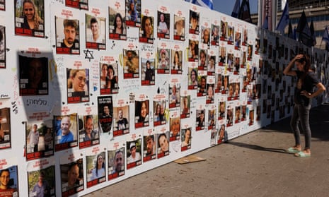 A member of the public looks at a wall displaying pictures of people still held hostage in Gaza. The confirmed number of people held hostage in the Gaza Strip since the 7 October cross-border raids by Hamas has now risen by two to 224, according to the Israeli military.
