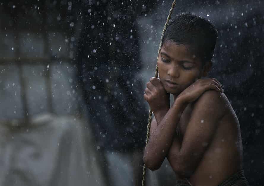 Rohingya boy in the rain