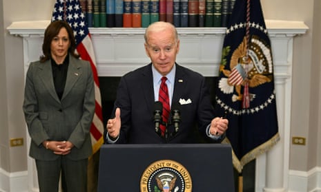 Joe Biden, with Kamala Harris, speaks to reporters in the Roosevelt Room of the White House.
