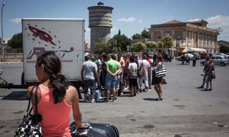 Migrant workers arriving at the bus station in the town of Vittoria