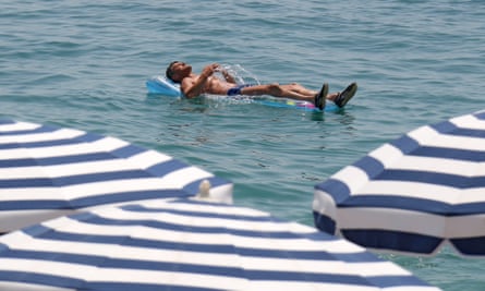 A man relaxes in the Mediterranean in Nice, France.
