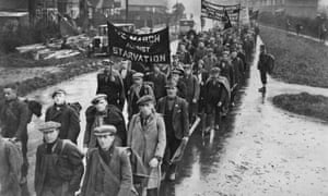 Unemployed men on a hunger march pass through a British town, circa 1935.
