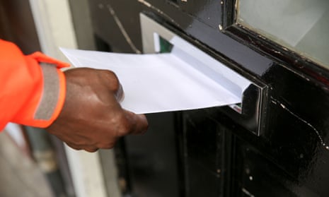 A Royal Mail postman delivers a letter