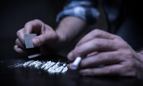 A person chopping lines of cocaine.