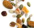 Trail mix of nuts and dried fruit isolated on white background