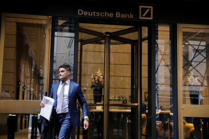 A man holding an envelope walks out of the lobby of the U.S. headquarters of Deutsche Bank in New York City, U.S., July 8, 2019. REUTERS/Andrew Kelly
