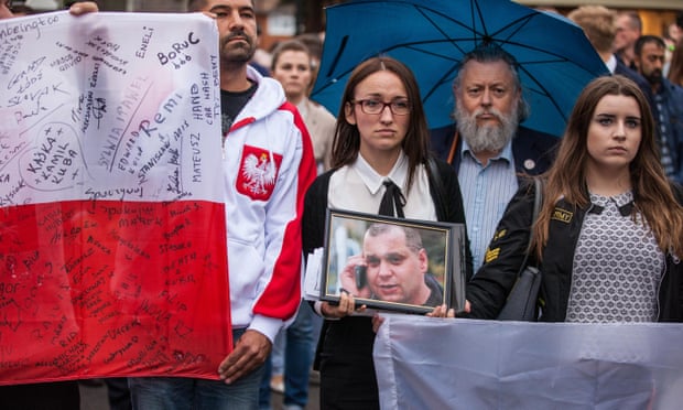 People take part in a silent march in memory of Arkadiusz Jóźwik
