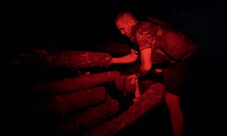 A Ukrainian soldier reinforces a trench at the frontline near Bakhmut, eastern Ukraine