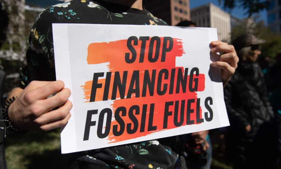A sign protesting the IMF and World Bank investments in fossil fuels.