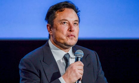 Elon Musk holding a microphone