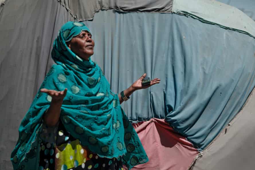 Koos Mohammed, chairperson of the camp for displaced people in Borama, stands in the sun outside a shelter